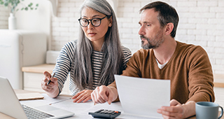 middle-aged couple reviewing their finances